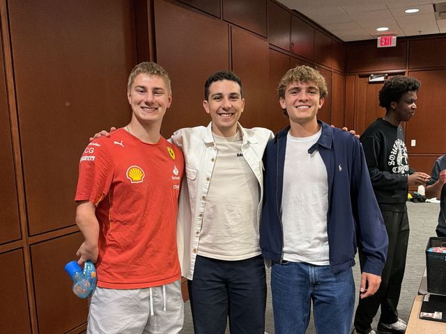 Three friends at an event on campus