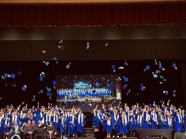 Graduation caps flying at the ceremony