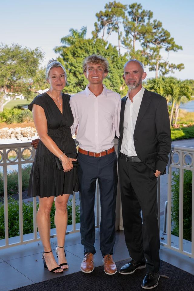 Tyler with his parents at a formal event
