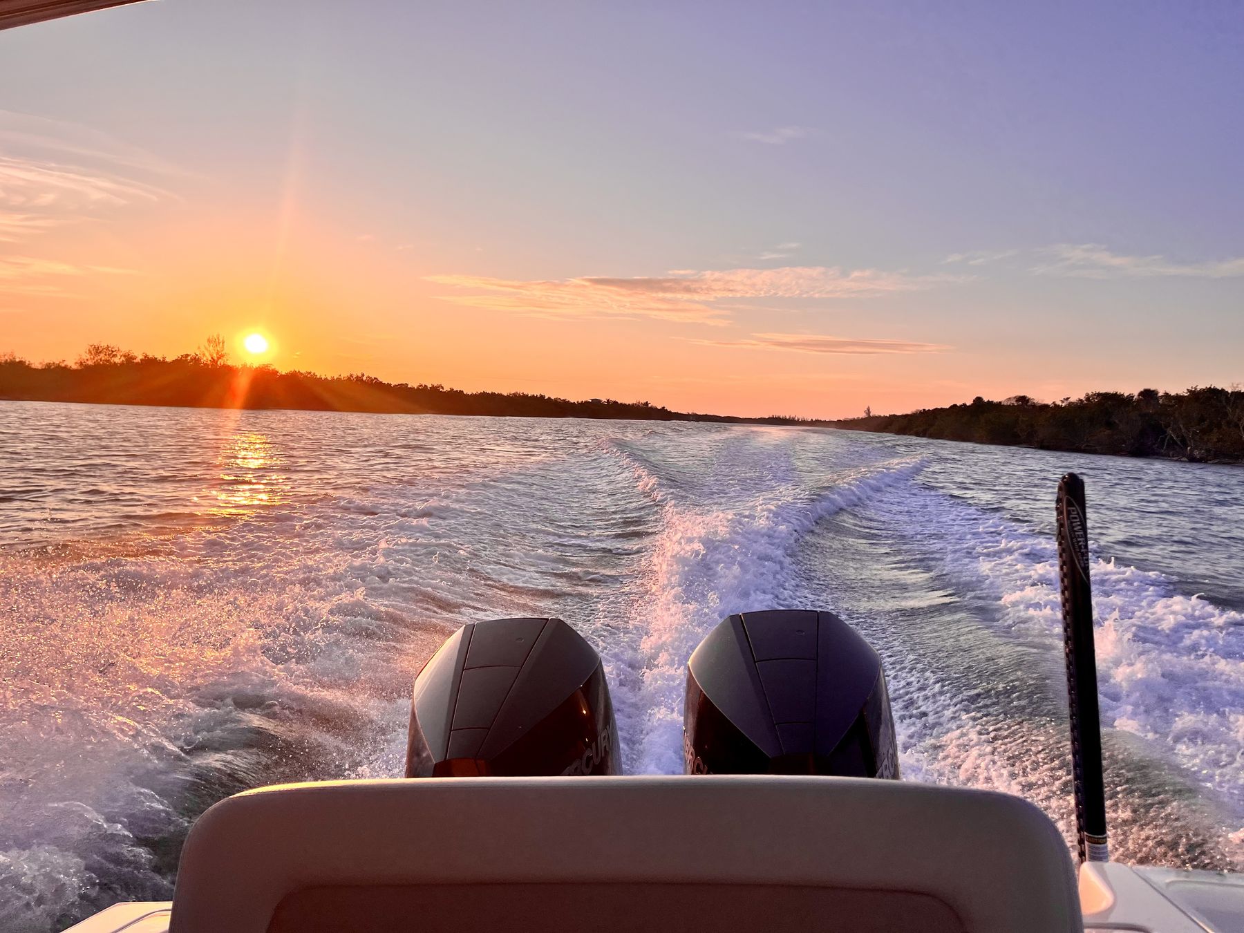 Sunset over the wake behind the boat